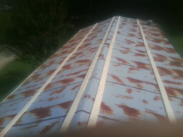 Rusted metal roof panels with new wood purlins before replacement — Storm Damage Roof Repair in Hammett by Roofing Brothers